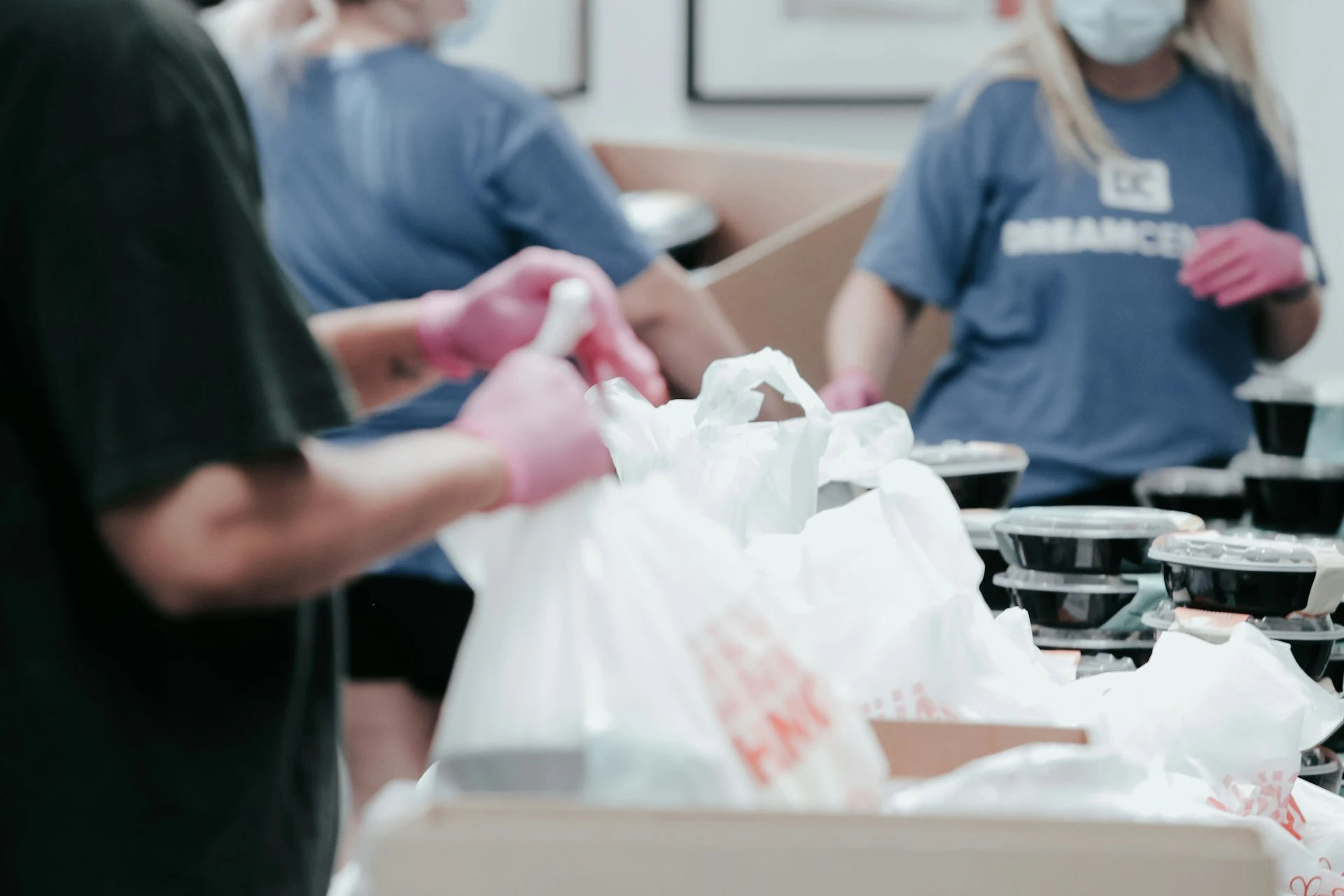 Volunteers filling bags with food